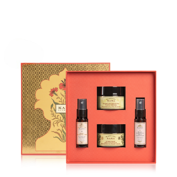 Skincare product set with jars and bottles in a decorative box on a white background