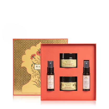 Skincare product set with jars and bottles in a decorative box on a white background