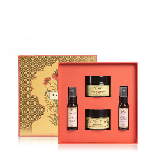 Skincare product set with jars and bottles in a decorative box on a white background