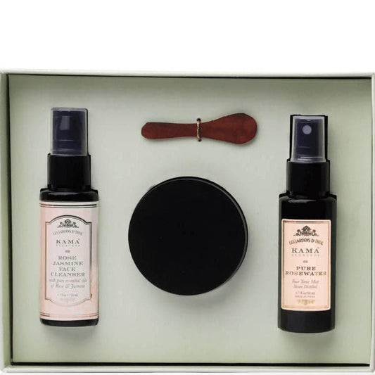 Set of beauty products including two bottles, a round disc, and a wooden tool in a box.