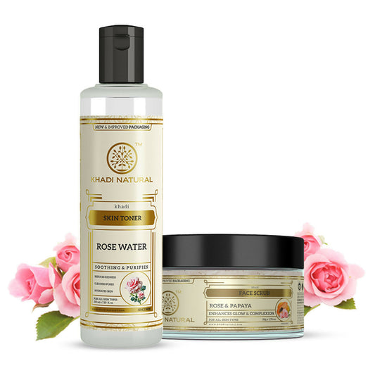 Khadi Natural skincare products with rose water toner and scrub on a white background with pink roses.