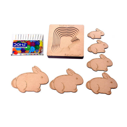 Wooden rabbit mold and stamps with color samples on a white background