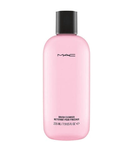 Pink bottle of MAC brush cleanser with black cap on a white background