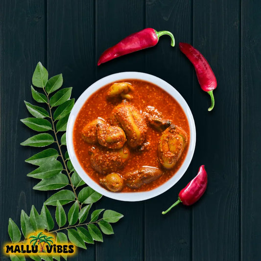 Bowl of curry with red peppers and a leaf on a dark background, featuring the 'Mallu Vibes' logo.