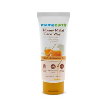 A tube of Mamaearth Honey Malai Face Wash with illustrations of honey and milk, indicating nourishing properties.