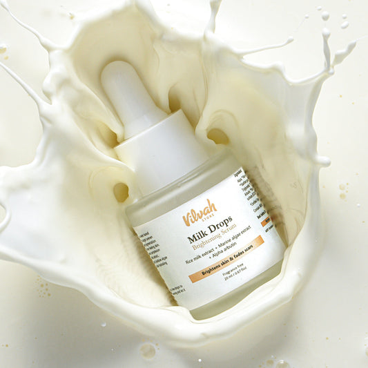 Vilivah Milk Drops skincare serum in a pool of milk
