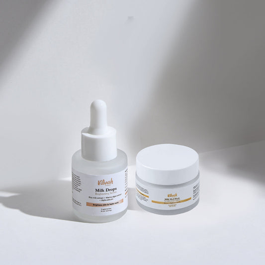 Skincare products with dropper bottle and jar on a light background