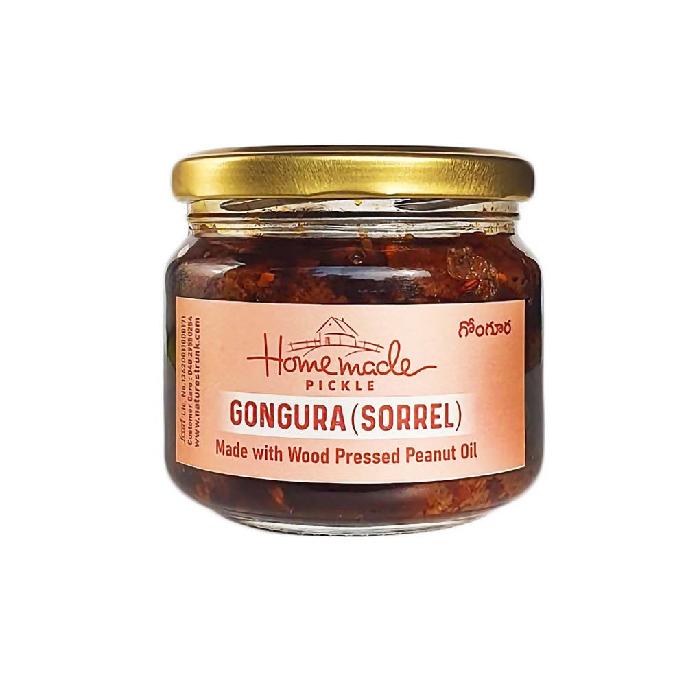 Jar of Gongura Sorrel pickle with a gold lid on a white background