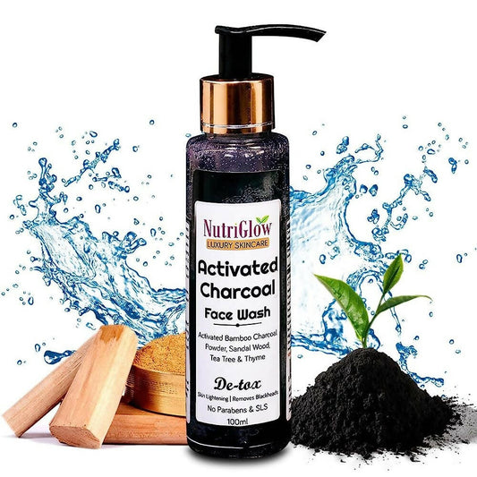 NutriGlow Activated Charcoal Face Wash bottle with charcoal powder and wooden spatula on a white background