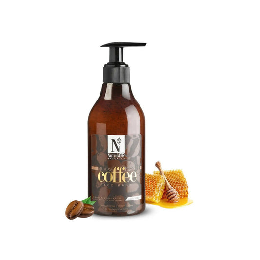 Bottle of raw coffee face wash with a pump, surrounded by coffee beans and honeycomb on a white background.
