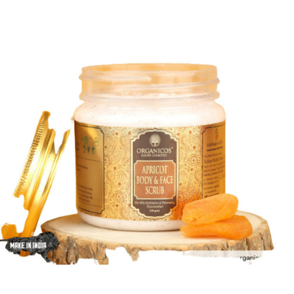 Jar of apricot body and face scrub with a comb and apricots on a wooden stand, branded 'Organicos'.