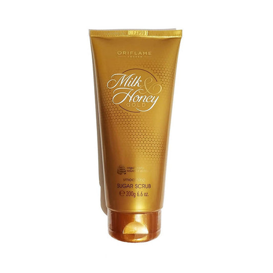 A gold-colored tube of Oriflame Milk & Honey Gold Smoothing Sugar Scrub with elegant text and detailing.