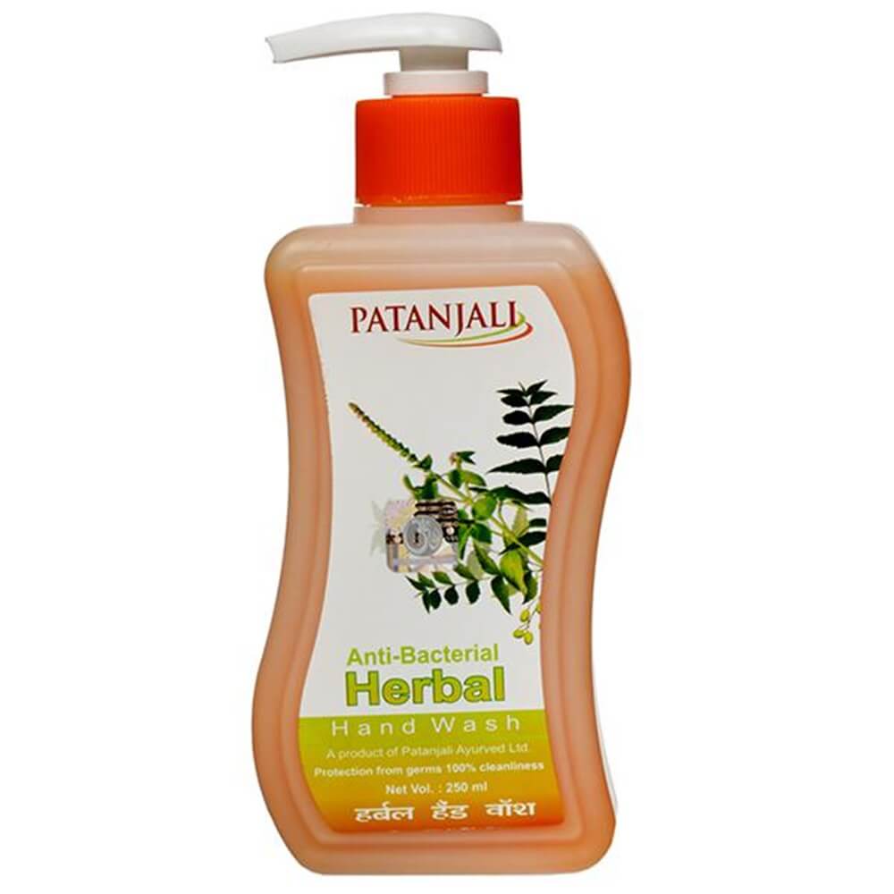 Patanjali Herbal Anti Bacterial Hand Wash in a clear plastic bottle with a red pump, featuring label with brand and product information.