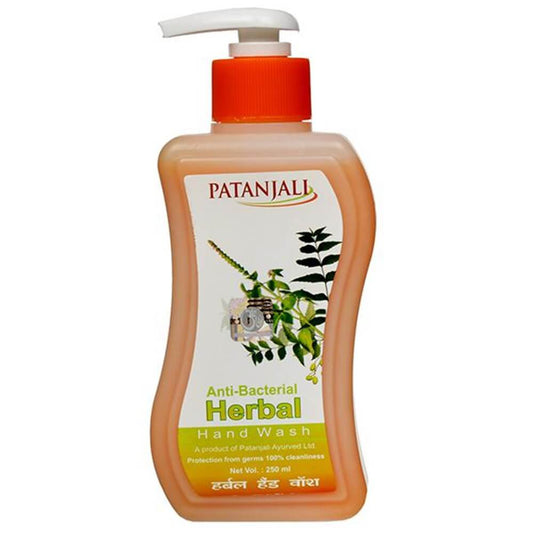 Patanjali Herbal Anti Bacterial Hand Wash in a clear plastic bottle with a red pump, featuring label with brand and product information.
