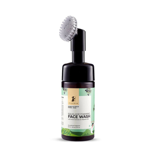 Bottle of face wash with a brush on a white background
