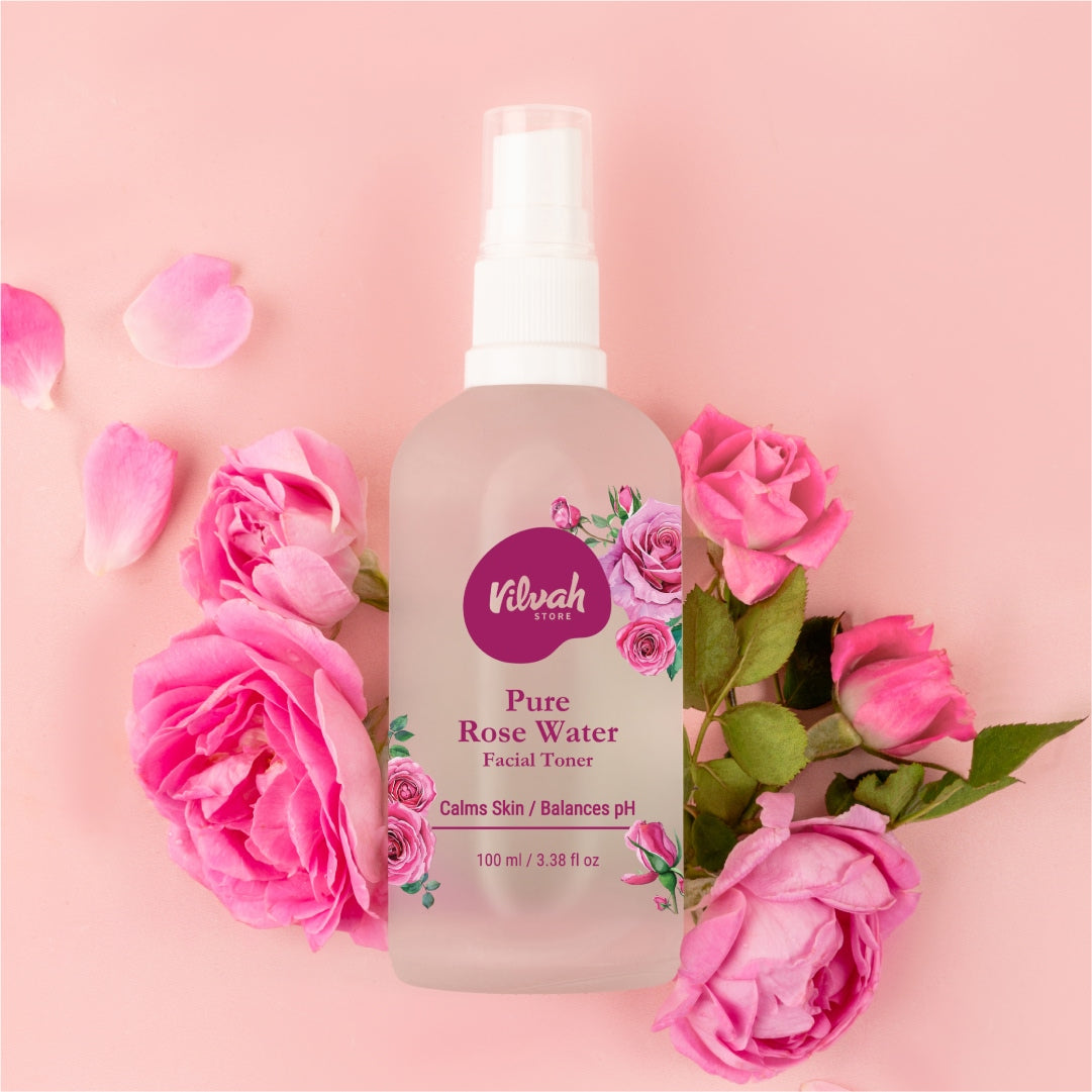 Vilvah Pure Rose Water facial toner bottle with pink roses on a pink background