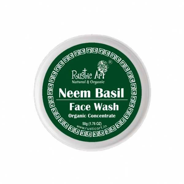 A container of Rustic Art Neem Basil Face Wash Organic Concentrate with green labeling and product details.