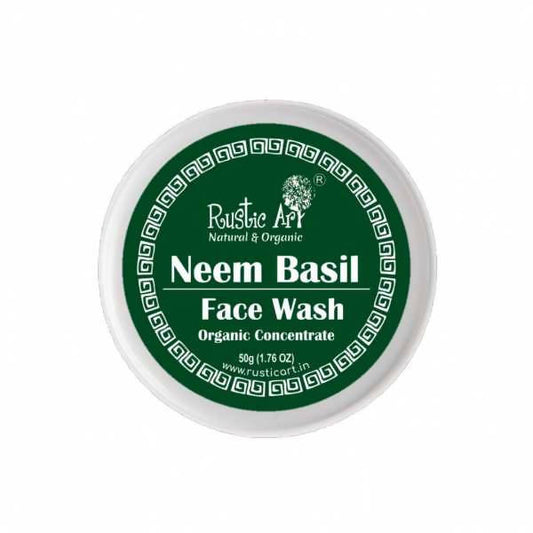 A container of Rustic Art Neem Basil Face Wash Organic Concentrate with green labeling and product details.