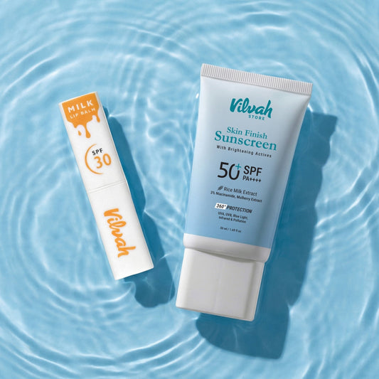 Two Vilvah sunscreen products on a water background