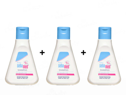 Three bottles of Sebamed shampoo with blue lids on a white background