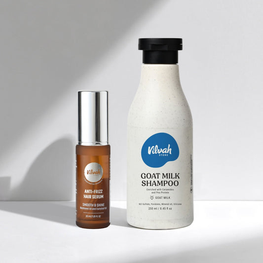 Vilvah goat milk shampoo bottle and hair serum on a white background