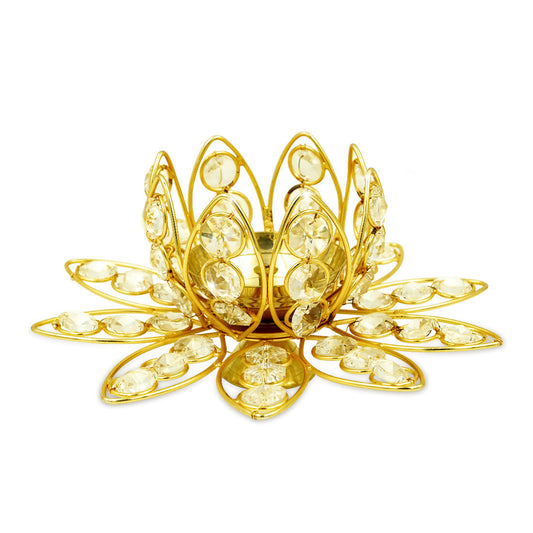 Gold decorative candle holder with crystal-like stones on a white background