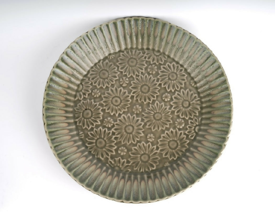 Decorative ceramic plate with floral patterns on a white background
