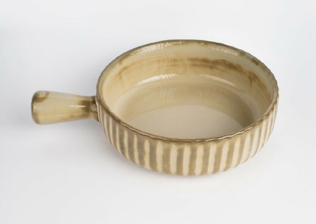 Ceramic bowl with handle on a white background