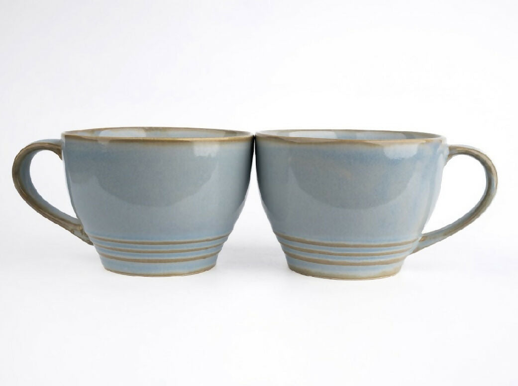 Two gray ceramic mugs with brown accents on a white background