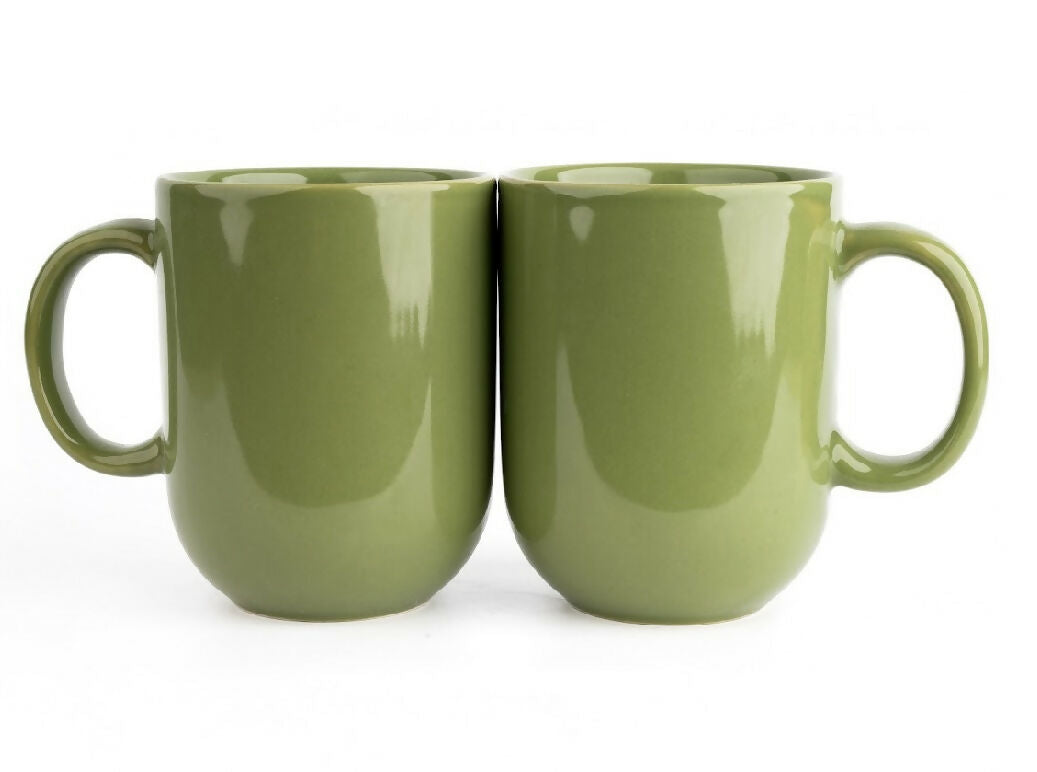 Two green ceramic mugs on a white background