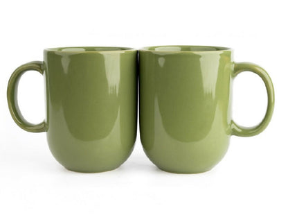 Two green ceramic mugs on a white background