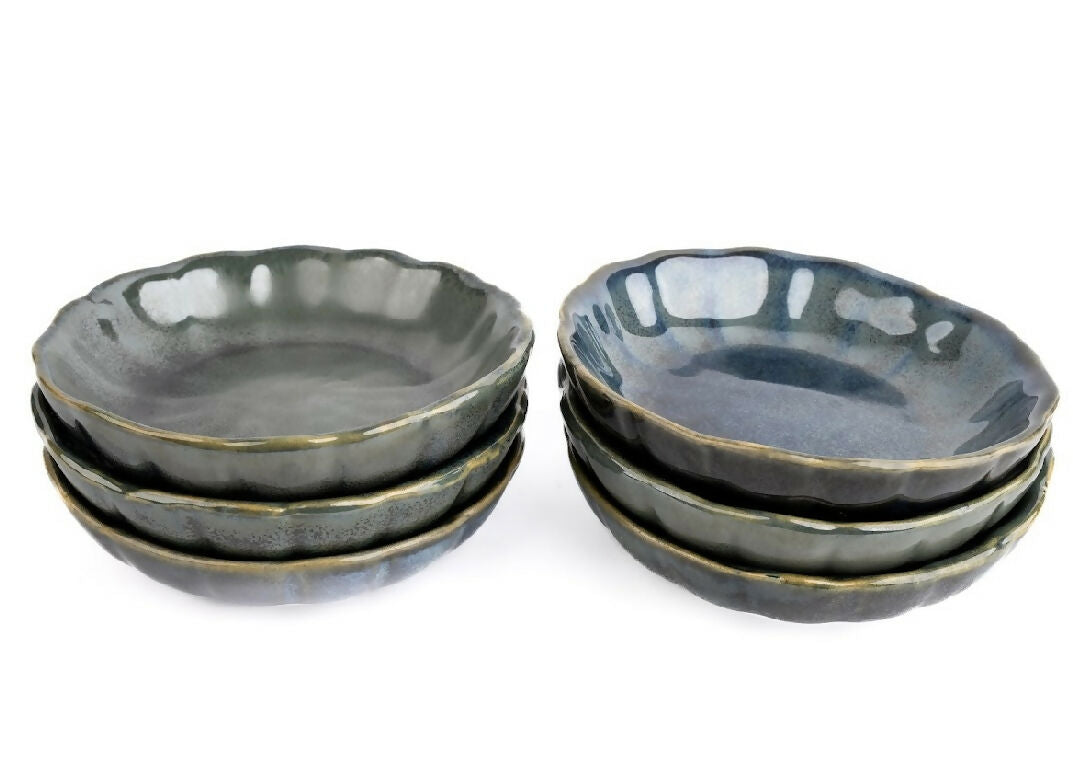 Set of four dark gray ceramic bowls on a white background