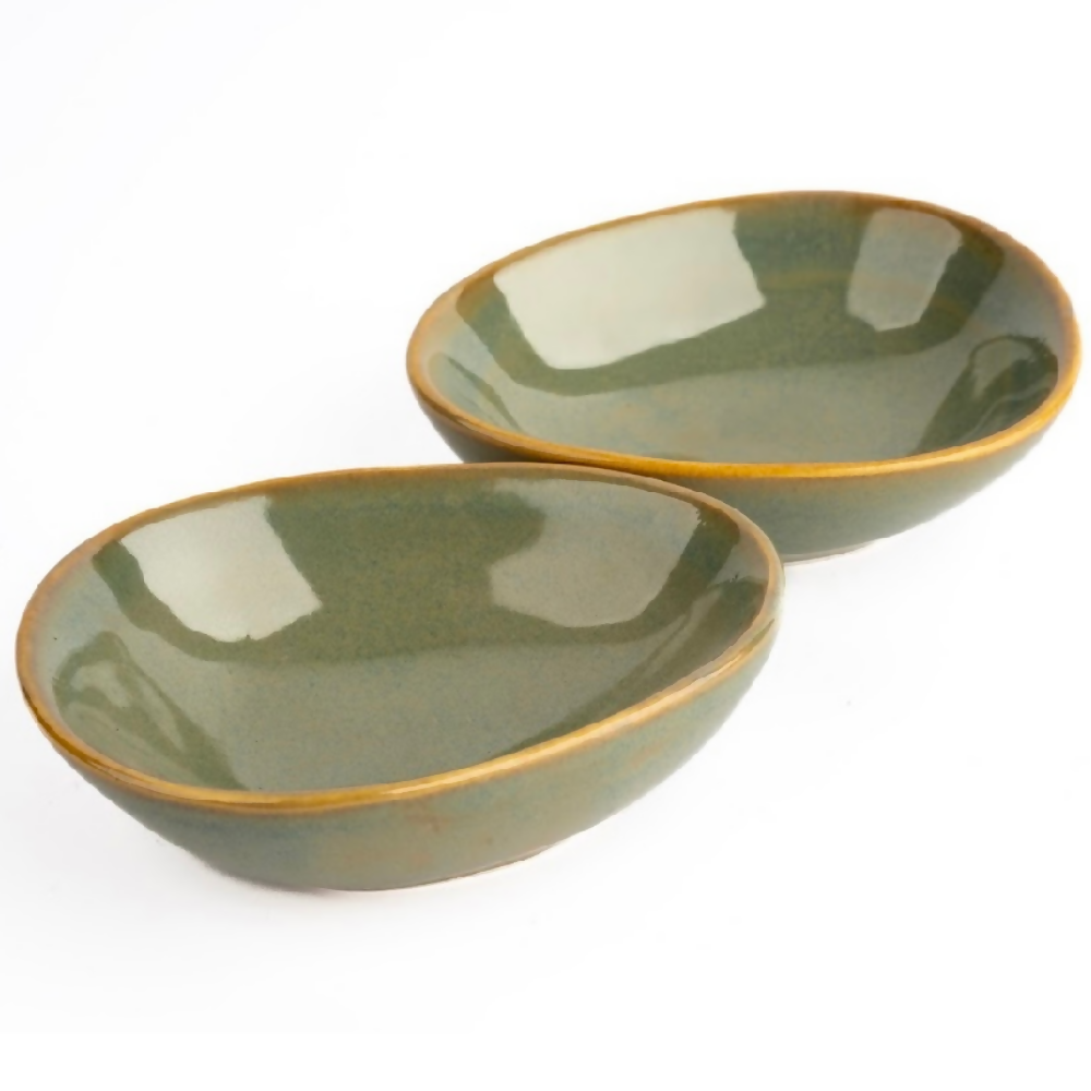 Two green ceramic bowls on a white background