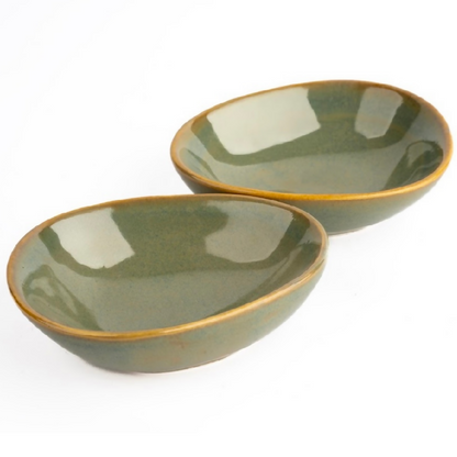 Two green ceramic bowls on a white background