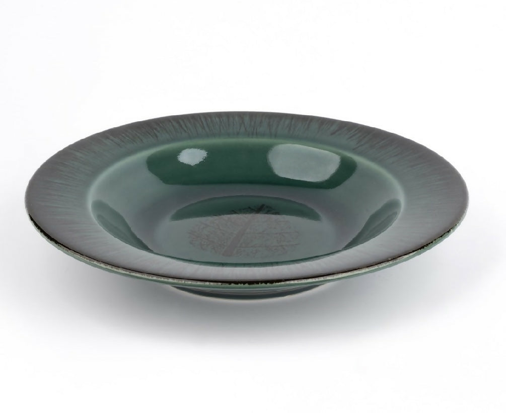 Green ceramic bowl on a white background