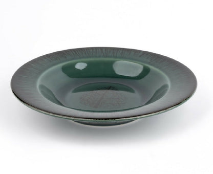 Green ceramic bowl on a white background