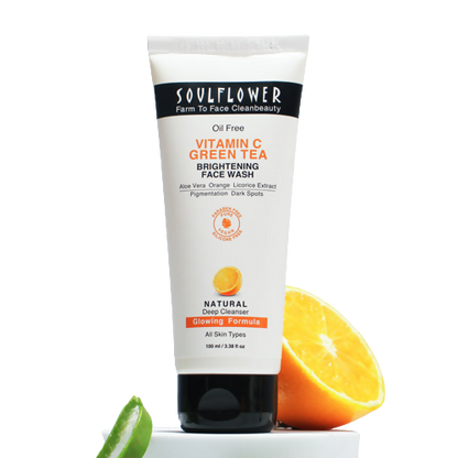 Soulflower Vitamin C Green Tea Brightening Face Wash with an orange and lime on a white background