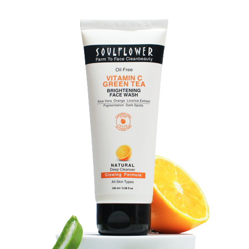 Soulflower Vitamin C Green Tea Brightening Face Wash with an orange and lime on a white background