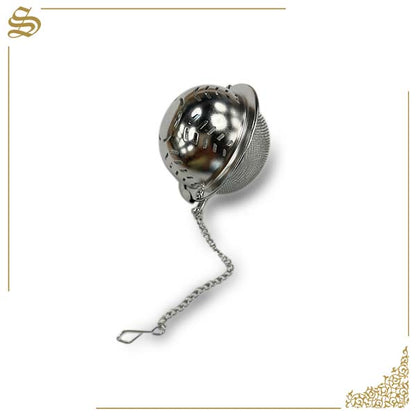 Metallic tea ball infuser with chain on a white background