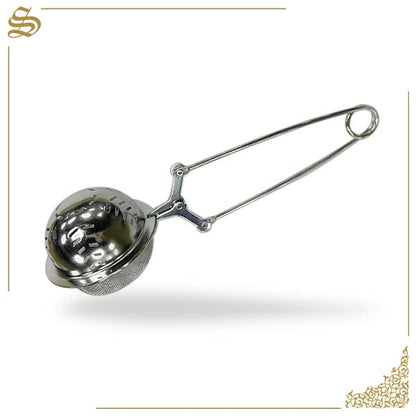 Metallic tea ball on a white background