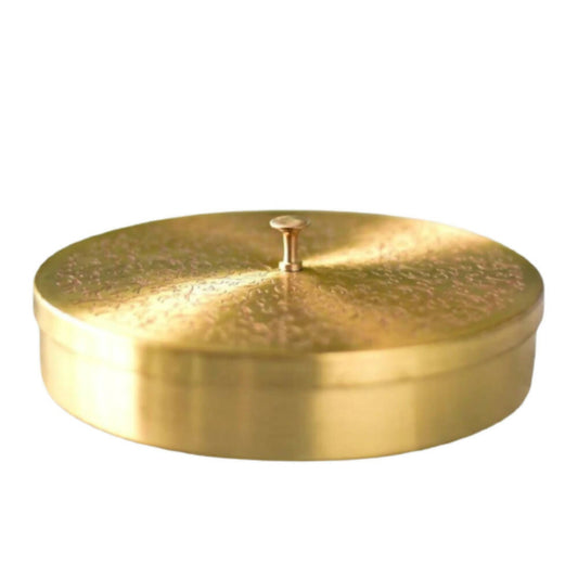 Gold circular object with a central spike on a white background