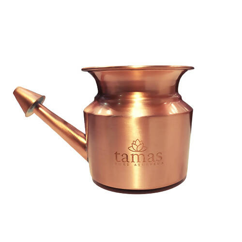 Copper watering can with 'tamas' branding on a white background
