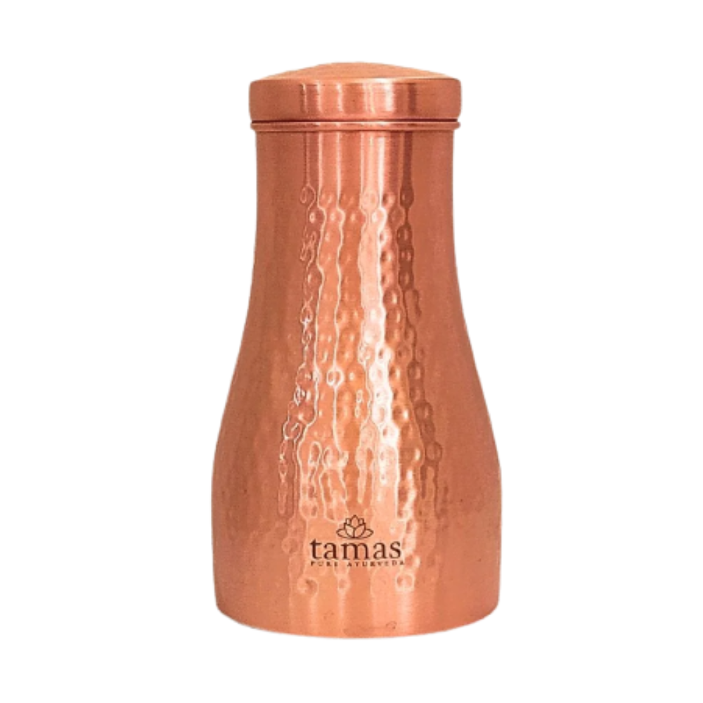 Copper tumbler with textured surface and 'tamas' branding on a white background