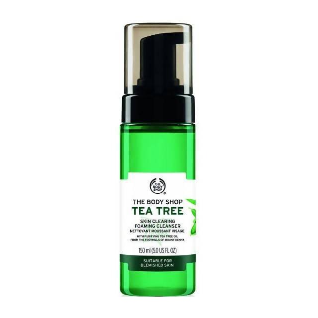 Green bottle of The Body Shop Tea Tree Skin Clearing Foaming Cleanser on a white background