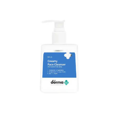 Bottle of Creamy Face Cleanser with blue label on a white background