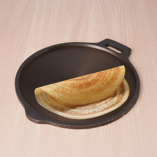 Folded omelette on a cast iron skillet with a wooden background