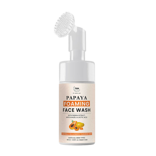 Papaya foaming face wash bottle with brush on a white background