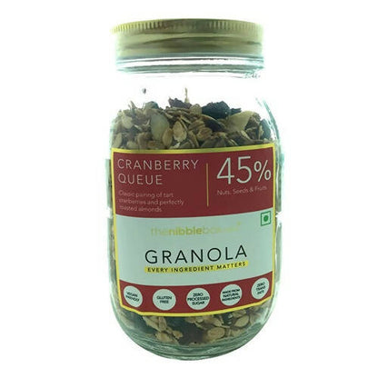 Jar of cranberry queue granola with a label on a white background