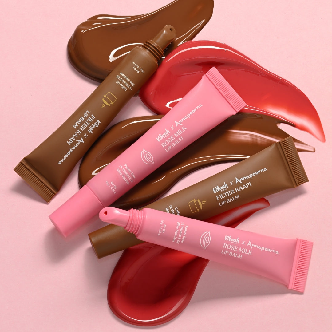 Lip balm tubes with visible brand names on a pink background