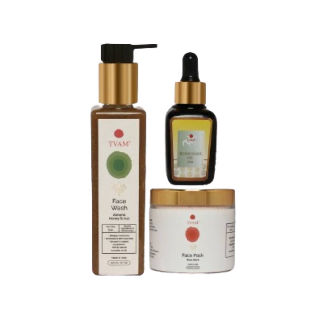 Set of three skincare products including a face wash, oil, and cream on a white background
